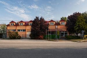 a building with a fence in front of a street at Livija rooms in Petrovec