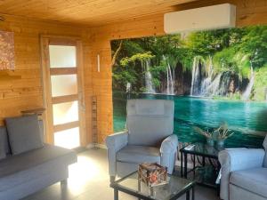 a living room with a waterfall mural on the wall at Enigma Lounge Chalet with swimming pool in Zutendaal
