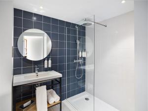 a bathroom with a shower and a sink and a mirror at Radisson Hôtel Bordeaux Saint-Jean in Bordeaux +29 photos