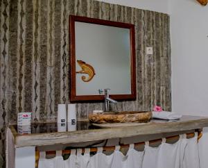 a bathroom with a sink and a mirror at Hotel Océan Beach Sakatia in Nosy Be +135 photos