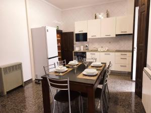 a kitchen with a table with chairs and a refrigerator at 57 in Porto