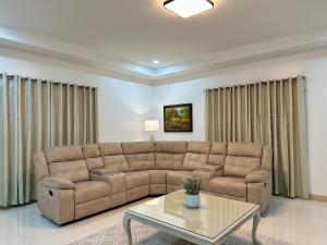 a living room with a couch and a table at The Penthouse at Sapphire in San Agustin