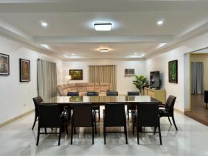 a dining room with a table and chairs and a couch at The Penthouse at Sapphire in San Agustin