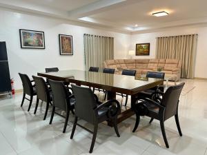 a dining room with a table and chairs and a couch at The Penthouse at Sapphire in San Agustin