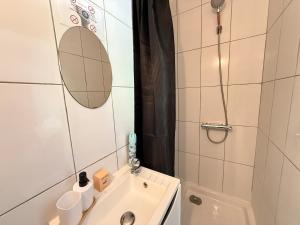 a small bathroom with a sink and a shower at Studio cosy parking in Margny-lès-Compiègne