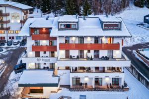 a large building with snow on the ground at Residence Diamant in Andalo