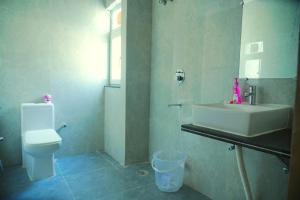 a bathroom with a sink and a toilet at Bunk Hostel Tapovan in Rishīkesh
