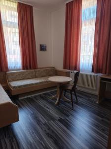 a living room with a couch and a table at Vinami Hotel - Bad Wildbad in Bad Wildbad