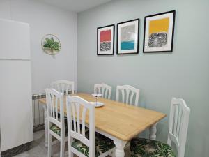 a dining room with a wooden table and chairs at Hotel Rodeiramar in Cangas de Morrazo +80 photos