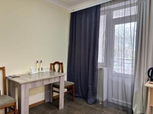 a room with a table and a window with curtains at Hotel Basen in Sisian +21 photos