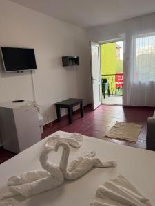 a white towel forming a heart sitting on a bed at Angely Summer Vila in Eforie Nord