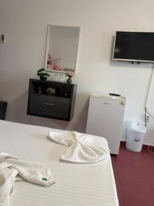 a room with a bed and a tv and a mirror at Angely Summer Vila in Eforie Nord +23 photos