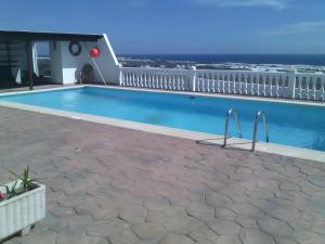 a swimming pool on top of a building with the ocean at Finca La Calera Lanzarote - Calma in Güime +2 photos