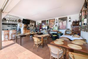 a restaurant with tables and chairs in a room at Finca La Calera Lanzarote - Calma in Güime