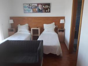 a hotel room with two beds and a couch at Finca La Calera Lanzarote - Calma in Güime
