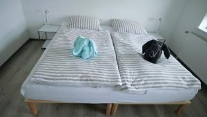 a bed with two pillows and towels on it at Appelholt in Wremen