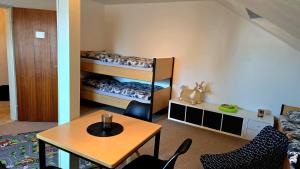 a room with two bunk beds and a table at Haus-Alter in Wilhelmshaven