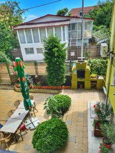 a patio with a umbrella and a pool at Angely Summer Vila in Eforie Nord