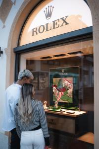 a man and a woman standing in front of a store window at Relais & Châteaux Chasa Montana in Samnaun