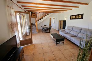 a living room with a couch and a table at Marques - holiday home with private swimming pool in Benitachell in Benitachell