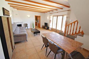 a living room with a table and a couch at Marques - holiday home with private swimming pool in Benitachell in Benitachell