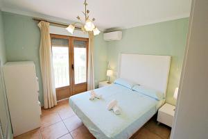 a bedroom with a bed with two towels on it at Marques - holiday home with private swimming pool in Benitachell in Benitachell +40 photos