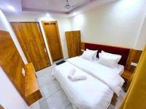 a bedroom with a bed with white shoes on it at Bunk Hostel Tapovan in Rishīkesh +19 photos