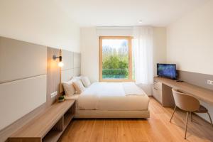a bedroom with a bed and a window at Cessange House by Rentaroo in Luxembourg