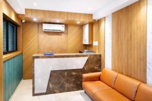 a waiting room with a couch in a room at Ruby Hotel in Mumbai