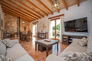 a living room with two couches and a table at Sa Punta in Son Carrió