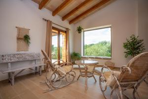 a living room with a table and chairs and a piano at Sa Punta in Son Carrió