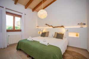 a bedroom with a large bed with towels on it at Sa Punta in Son Carrió +74 photos