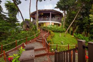 a building with stairs leading up to a house at Lihim Resorts in El Nido