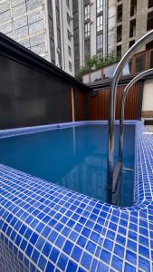 a swimming pool with a blue tiled at Orient Lux in Yakkasaray +15 photos