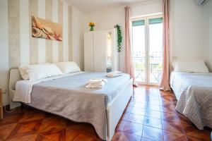 a bedroom with two beds with towels on it at Casa Immacolata in Polignano a Mare