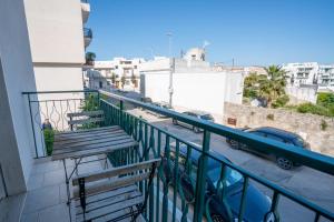 a balcony with benches and a view of a street at Casa Immacolata in Polignano a Mare +18 photos