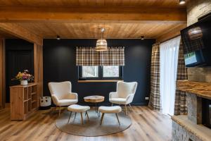 a living room with chairs and a table at Sadova Chalet in Sadova
