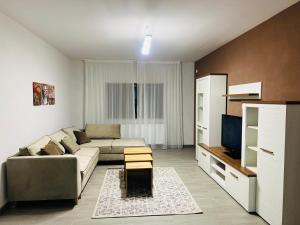 a living room with a couch and a tv at Casa Bradu in Mangalia