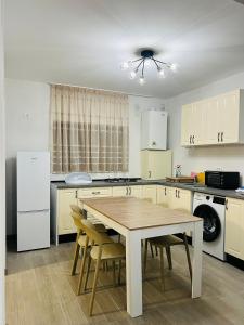 a kitchen with a table and chairs in it at Casa Bradu in Mangalia