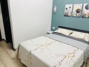 a bedroom with a bed and two pictures on the wall at Casa Bradu in Mangalia +2 photos