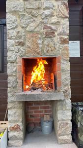 a stone oven with a fire in it at Les Trois Feuilles in Petit Mesnil