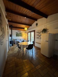 a kitchen and dining room with a table and chairs at Les Trois Feuilles in Petit Mesnil