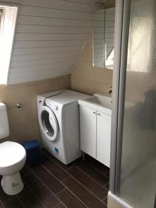 a bathroom with a washing machine and a sink at Handwerkerunterkunft in Elmshorn