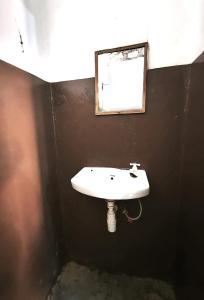 a bathroom with a white sink and a mirror at HOTSPOT inn - Malindi in Malindi
