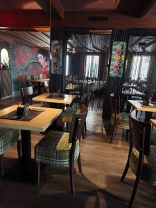 a dining room with wooden tables and chairs at Vinami Hotel - Bad Wildbad in Bad Wildbad