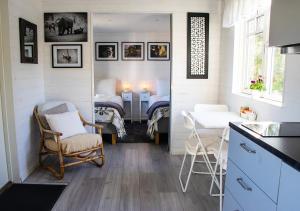 a kitchen with a room with a bed and a table at Tiny House Near Skokloster Castle in Uppsala