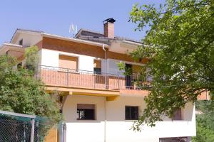 an apartment building with a balcony and trees at La Veiga Apartamentos Turísticos in La Riera