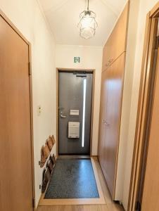 a hallway with a door to a bathroom with a trash can at 2026APR NEW Open! SETOUCHI BLUE BASE in Utazu