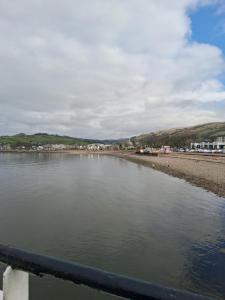 a body of water next to a beach at DRIFTWOOD coastal holiday flat - newly refurbished with 2 bedrooms in Largs