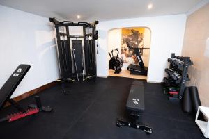 a fitness room with a gym with tread machines at Don Carlos in Paguera